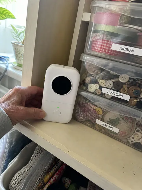 White label printer beside organized craft-supply bins