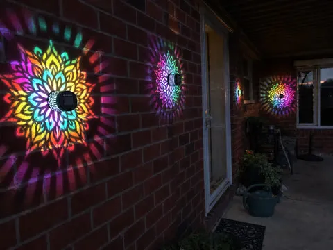 Four colorful mandala lights on a brick backyard porch