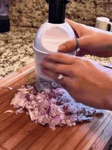 Manual press chopper quickly mincing onion