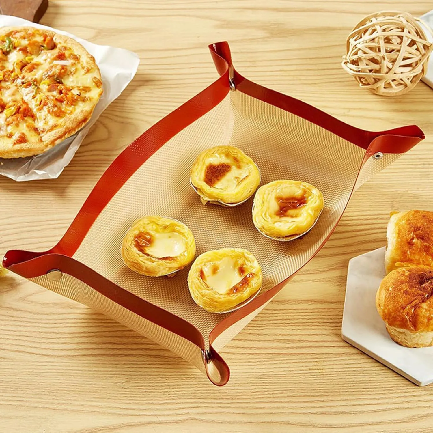 Red snap-corner baking mat formed into a shallow tray for pastries