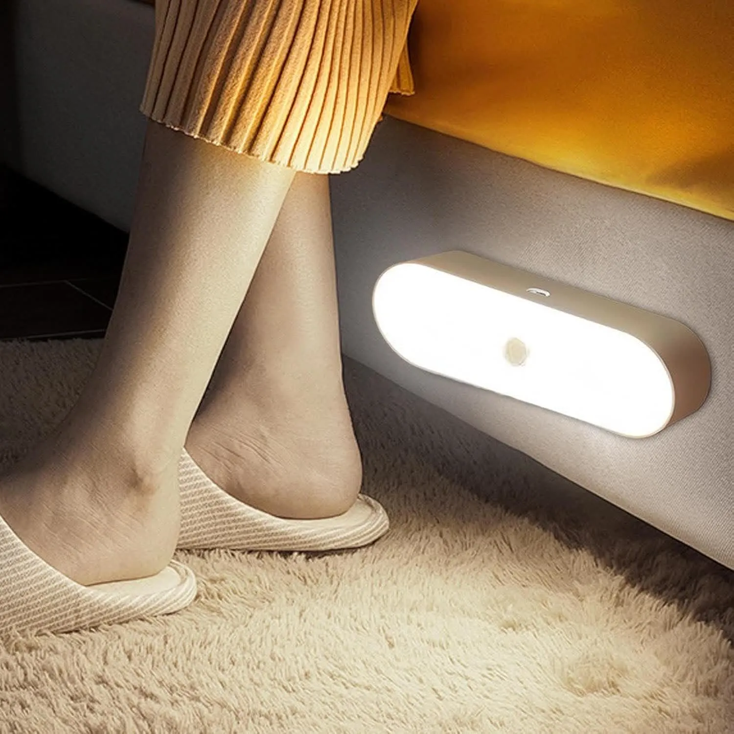 Motion sensor night light beside a bed