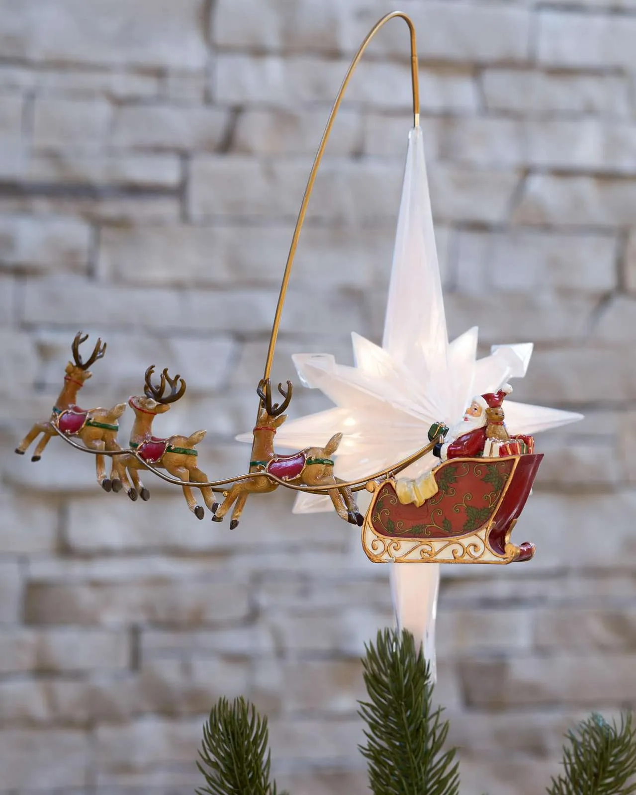 Animated Santa sleigh topper positioned above a Christmas tree