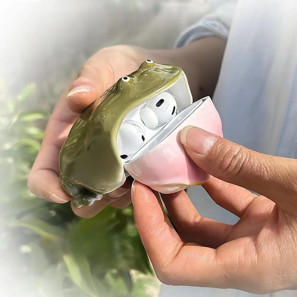 Green frog shell shown around and beside the earbud charging case