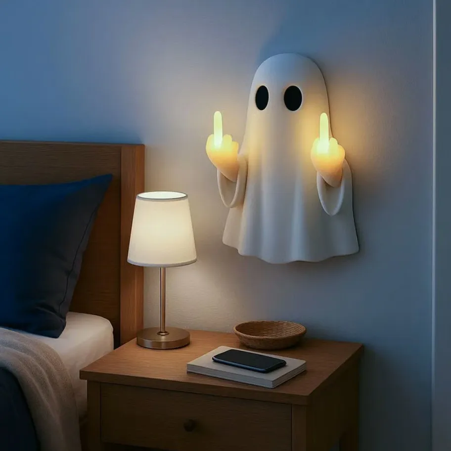 Ghost wall night light glowing above a bedroom nightstand