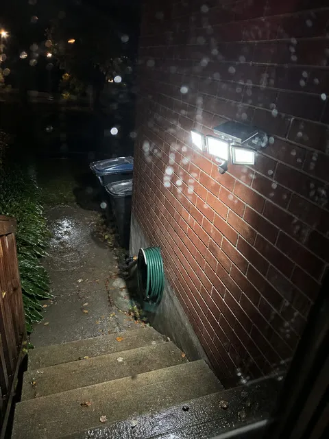 Rainy backyard steps illuminated by the three-head solar light