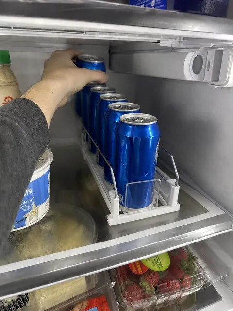 Organized soda row during refrigerator restocking