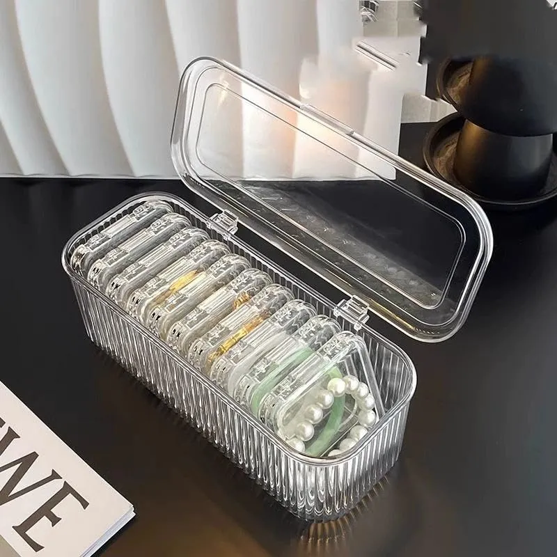 Clear jewelry organizer with one flip-lid outer case and fourteen removable mini cases
