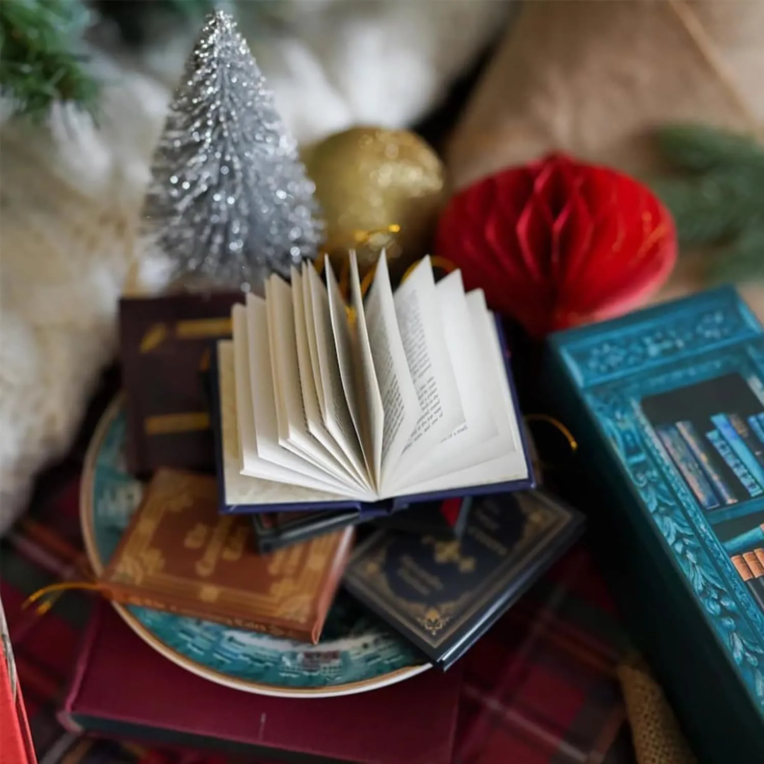 An open miniature paper book beside the advent calendar