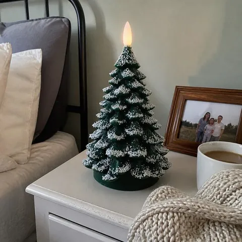 Tree candle glowing on a bedside table