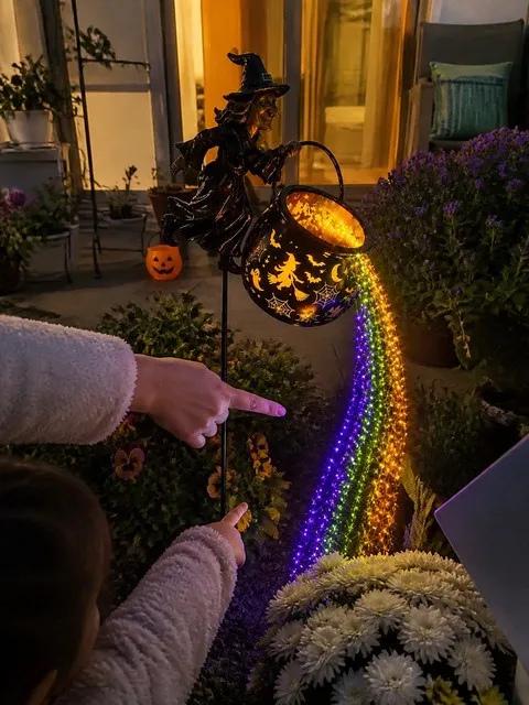 Parent and child enjoying the glowing cauldron light on a patio