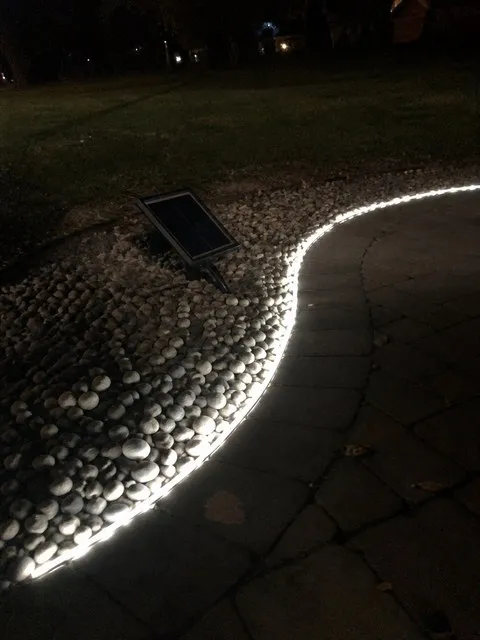 Solar light strip around a pebble path
