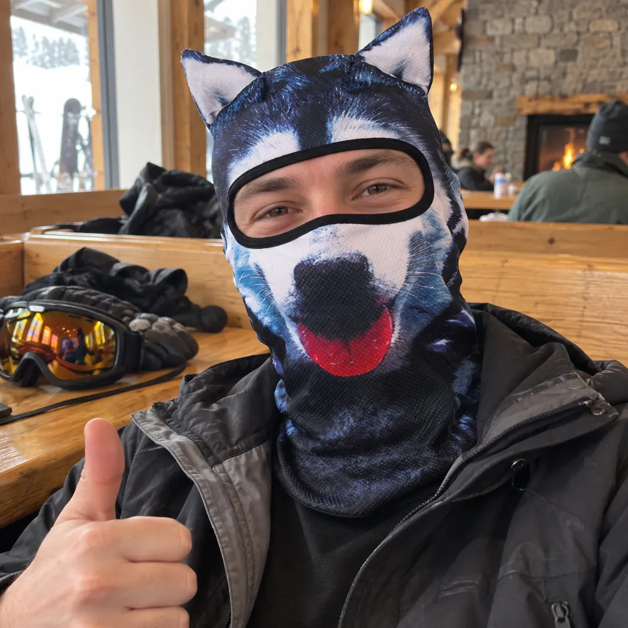 Dark husky animal hood worn in a casual ski lodge setting