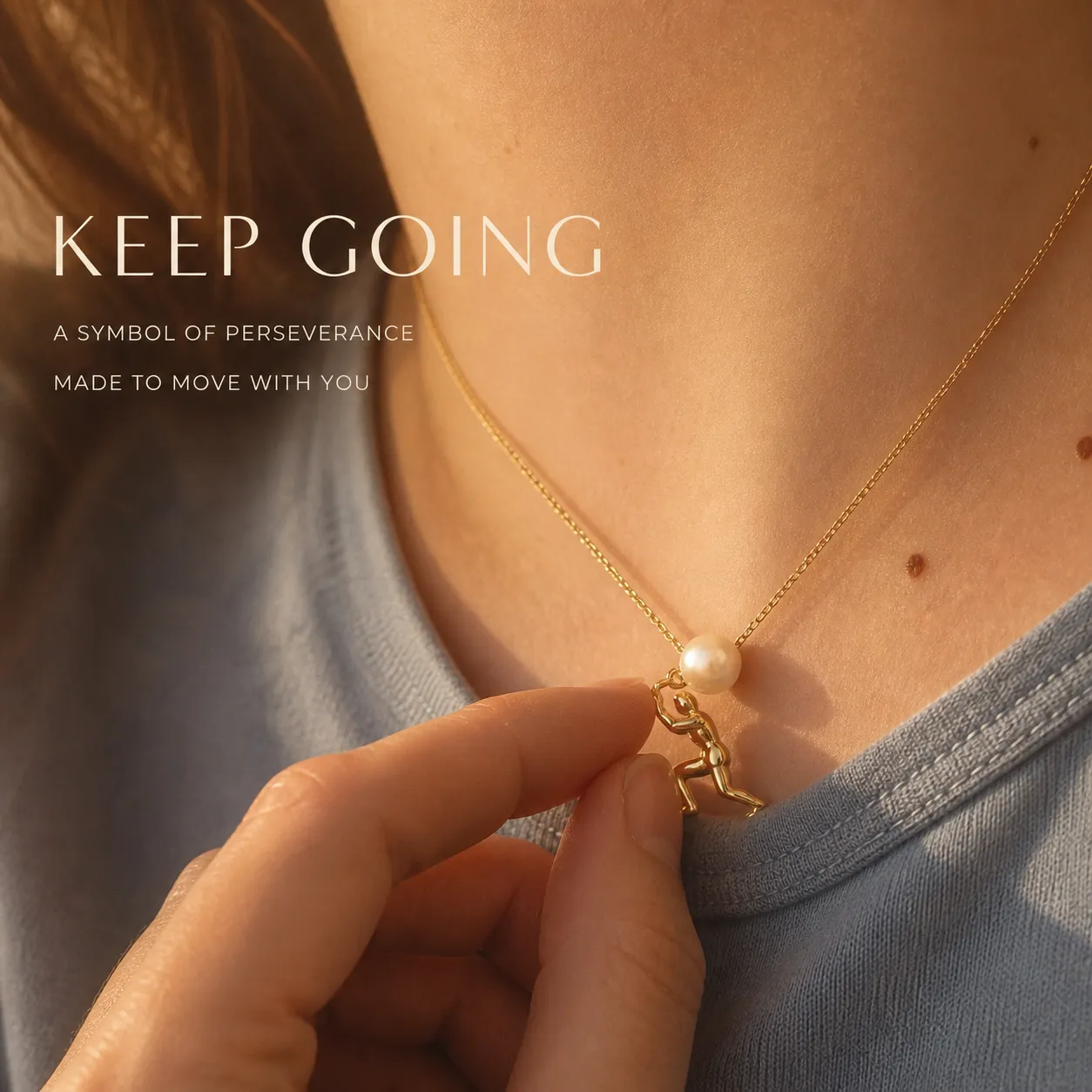 Gold-tone pearl pusher necklace worn as a reminder to keep going