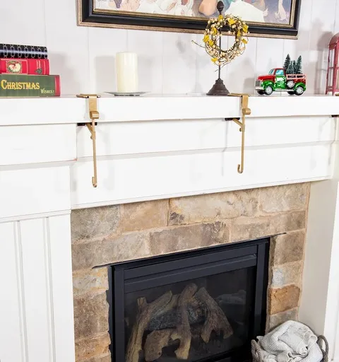 Gold hanger pair installed on a white fireplace mantel