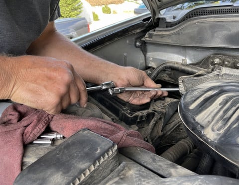 Flexible socket extension used during a driveway engine repair