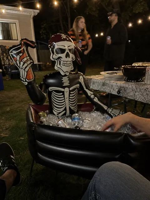 Pirate skeleton cooler at a casual nighttime backyard party