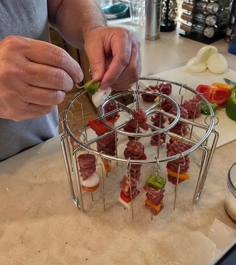 Home cook loading a hanging skewer rack