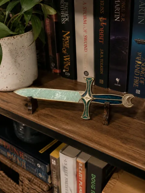 Mystic Green potion dagger displayed on a home bookshelf