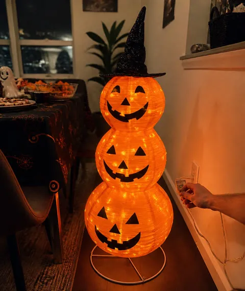 Lighted pumpkin lantern beside a Halloween party table