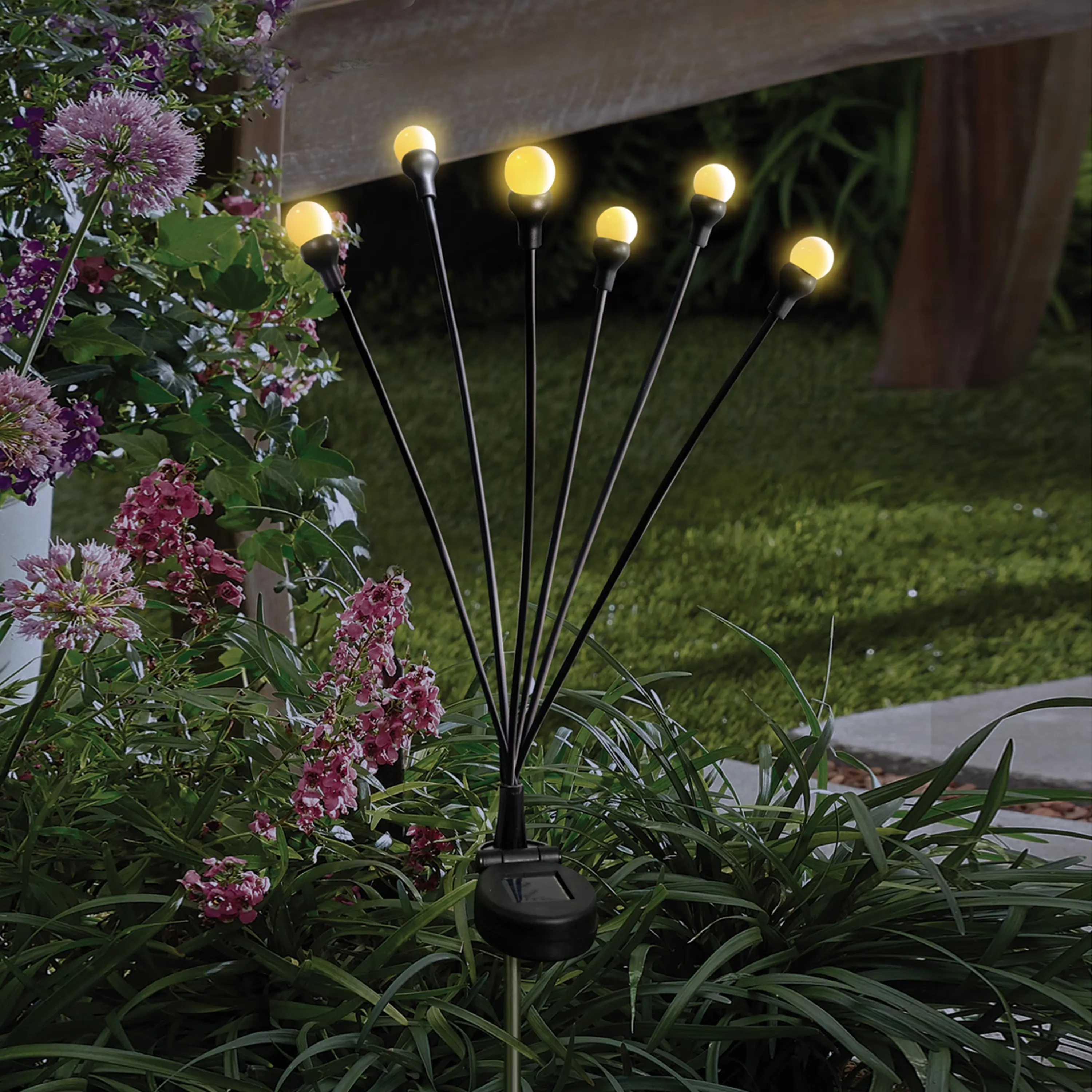 Warm white globe lights in a garden at night