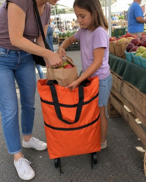 Orange rolling tote being loaded at a produce market