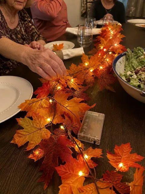 Glowing maple leaf garland used as a Thanksgiving table centerpiece