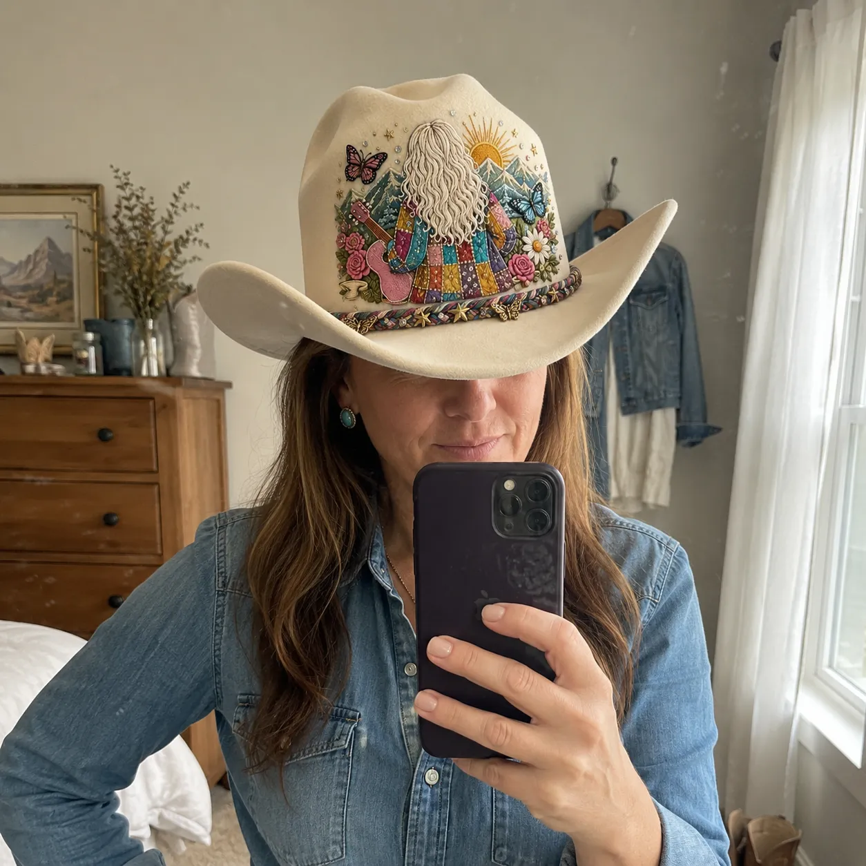 Customer mirror selfie wearing the cream Coat of Many Colors cowboy hat