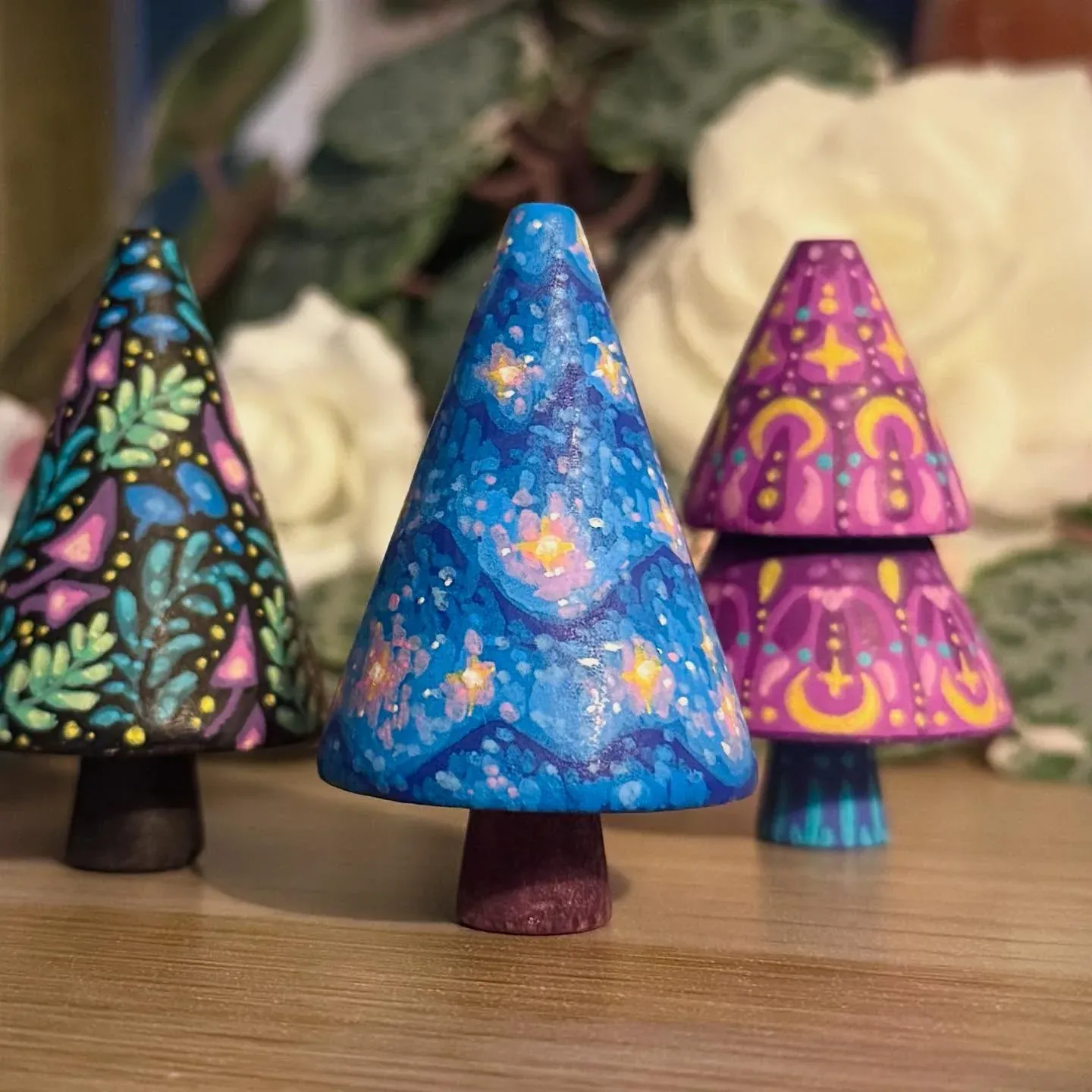 Three finished painted wooden trees
