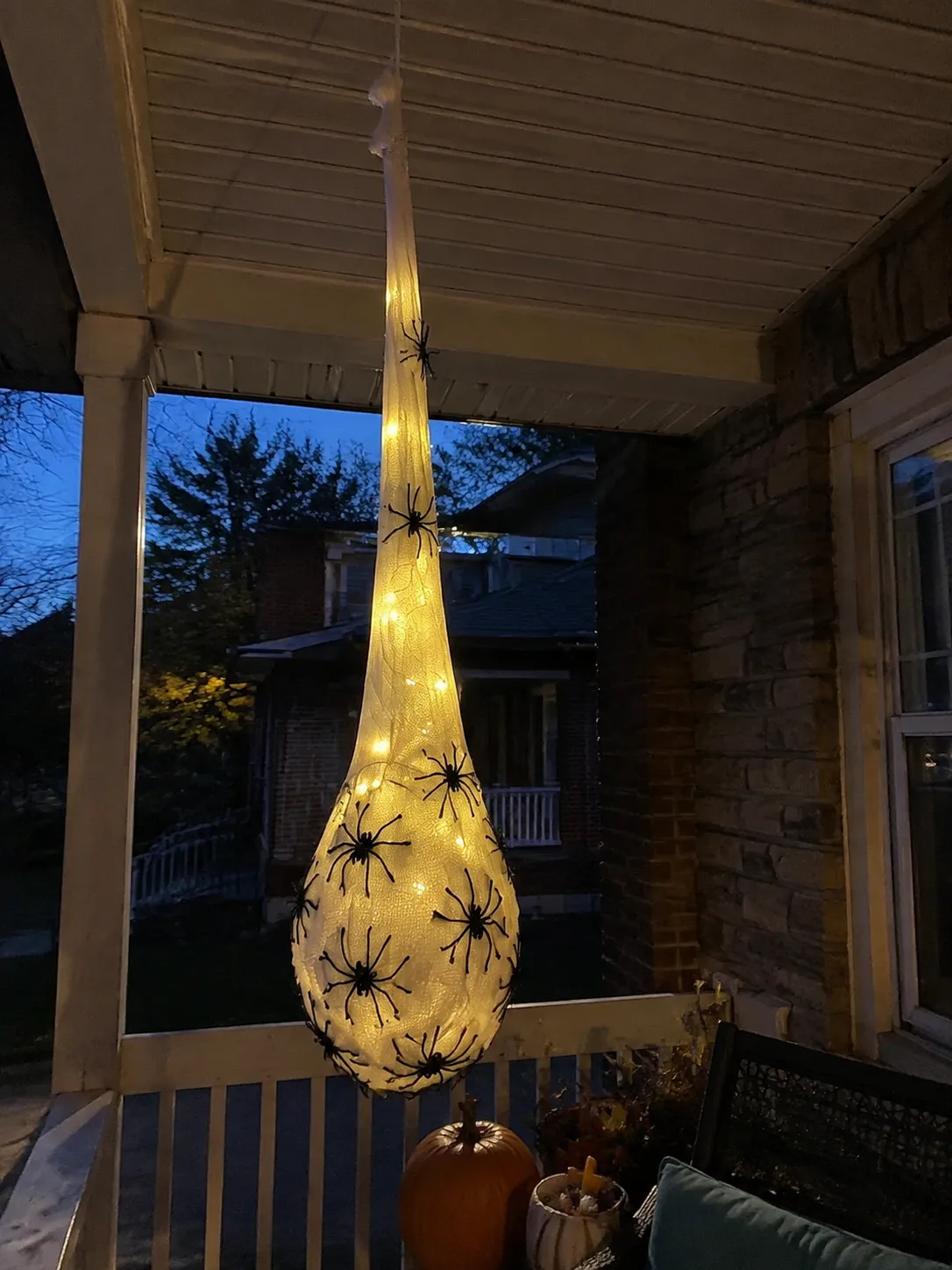 Glowing spider egg sac on a home porch