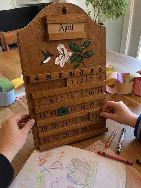 A parent and child arranging date blocks together