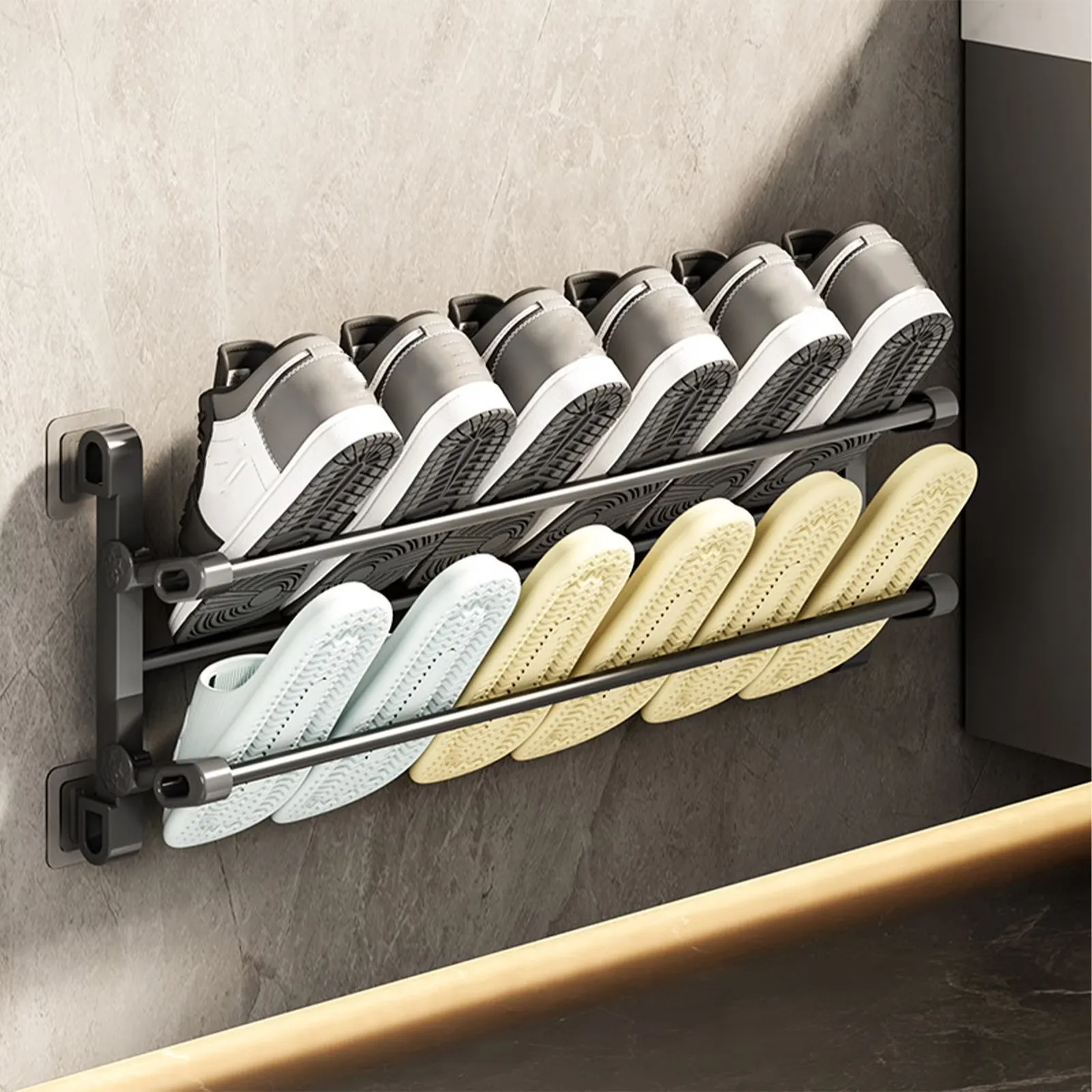 Black two-tier wall-mounted shoe rack holding everyday footwear