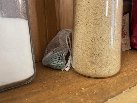 Mesh pouch tucked behind pantry canisters