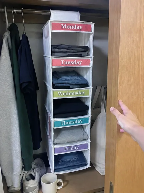 White weekday organizer inside a compact dorm wardrobe