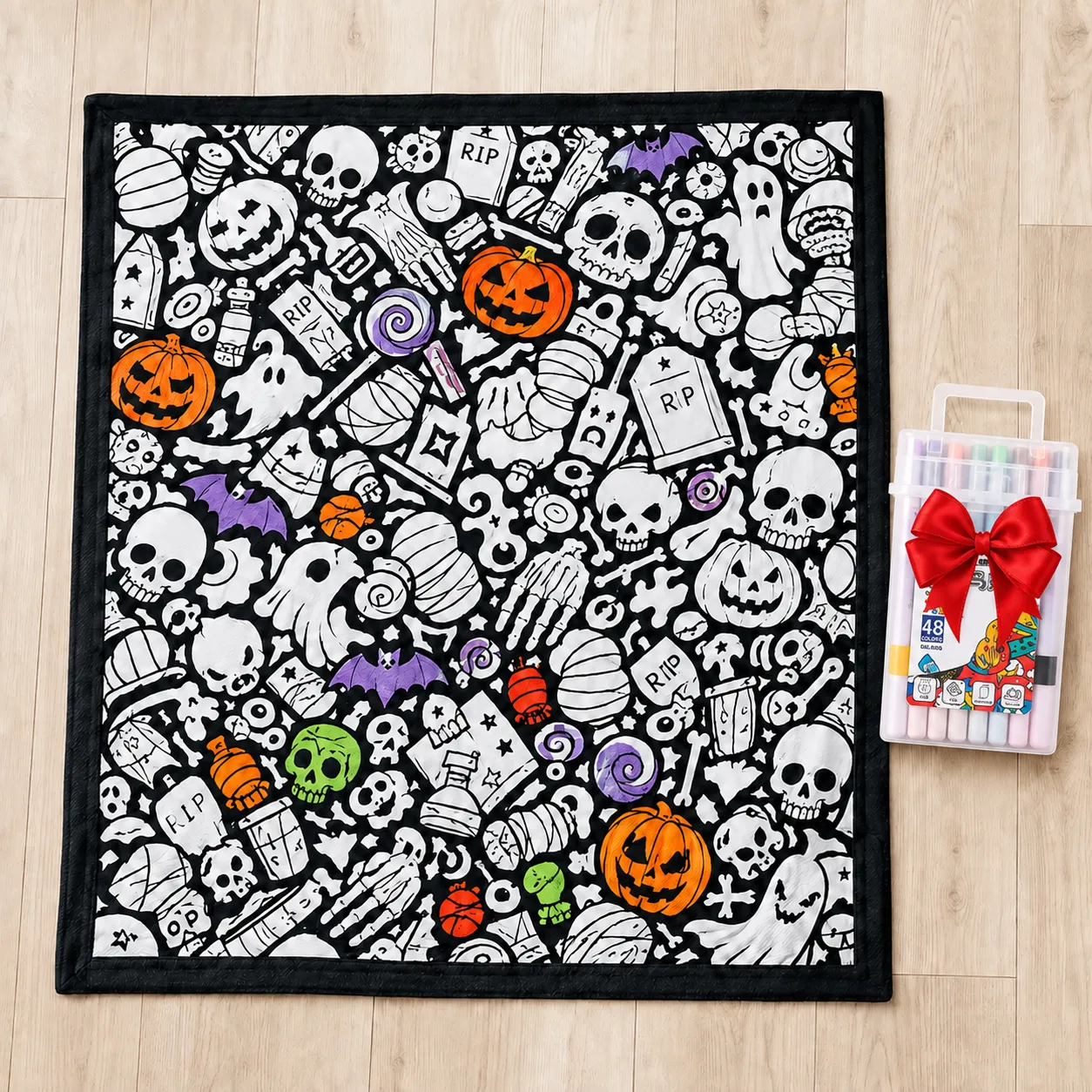 Halloween coloring blanket and included markers laid out