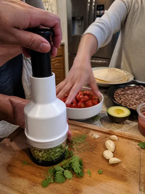 Family using the chopper while preparing taco toppings