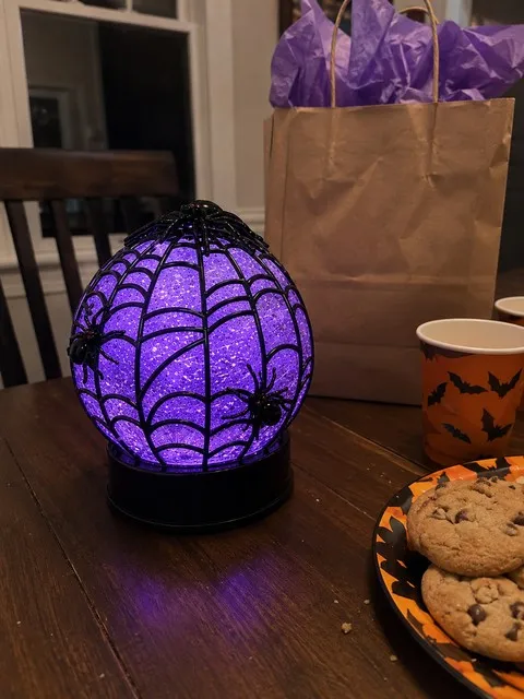 Spider glitter globe displayed after opening a Halloween gift