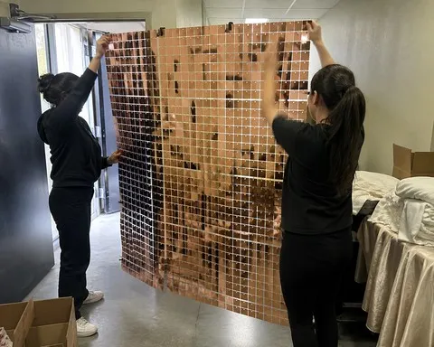 Event helpers holding a rose-gold shimmer panel section