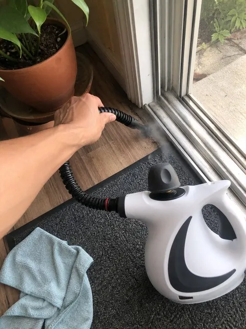 Flexible steam-cleaner hose used along a sliding-window track