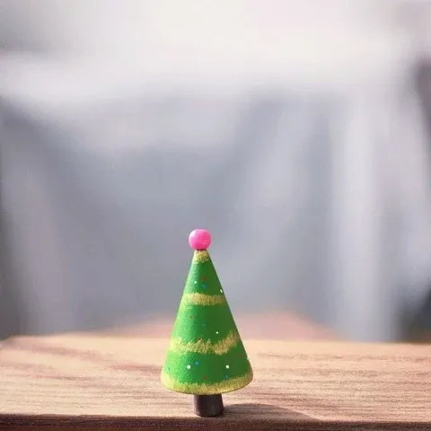 Green wooden tree with gold stripes and pink bead