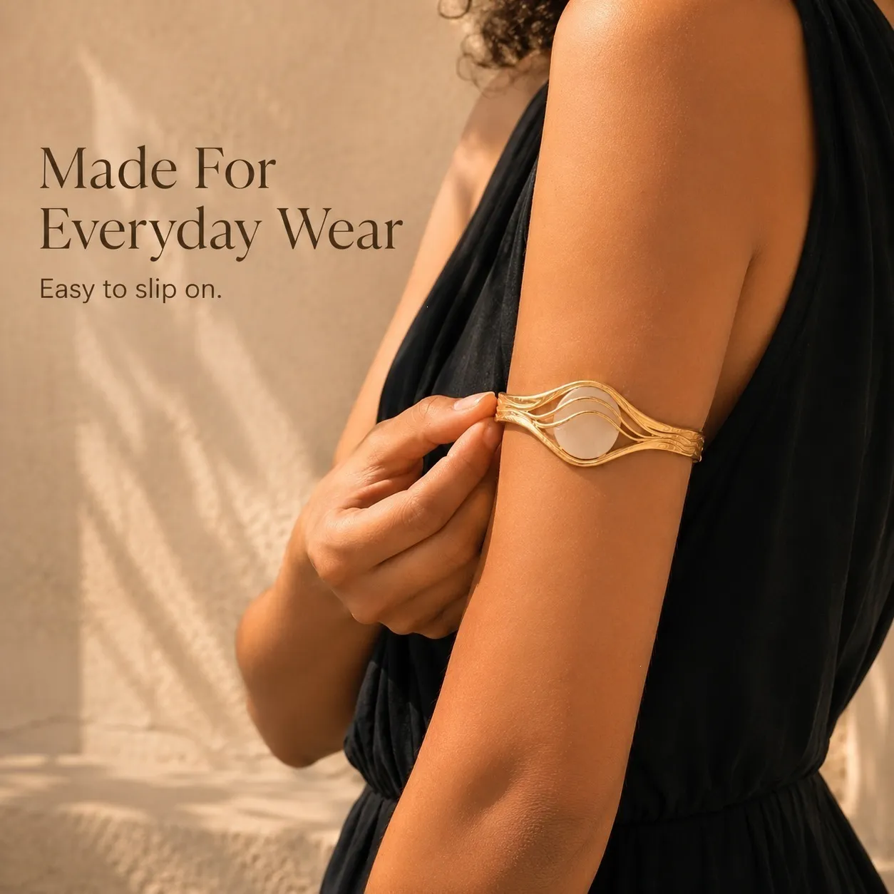 Gold sensor bracelet styled with an everyday black outfit