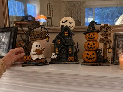 Three coordinated Halloween figurines on a farmhouse mantel
