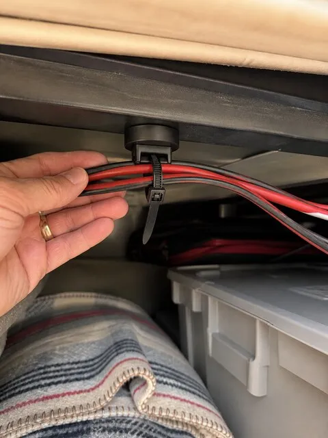 Customer-style photo of wires organized in an RV storage area