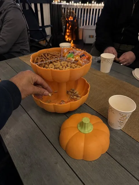 Orange pumpkin snack server at an outdoor Halloween gathering