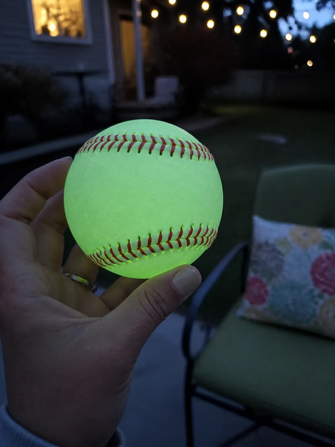 Glow baseball held in a backyard at dusk