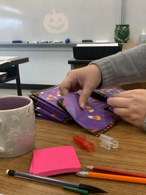 Finger projector lights prepared with Halloween classroom prize envelopes