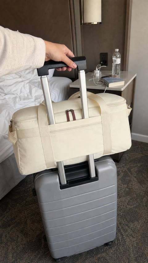 Rear trolley sleeve secured around a suitcase handle in a hotel room