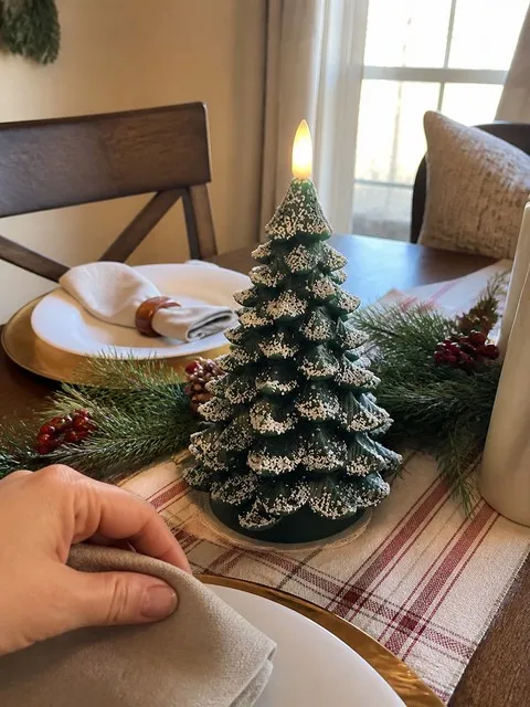 Tree candle in a holiday dining-table centerpiece