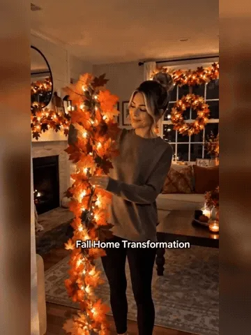 Maple leaf light garland being arranged and glowing indoors